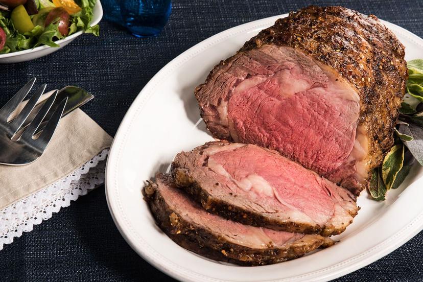 a-large-piece-of-meat-sitting-on-top-of-a-wooden-cutting-board