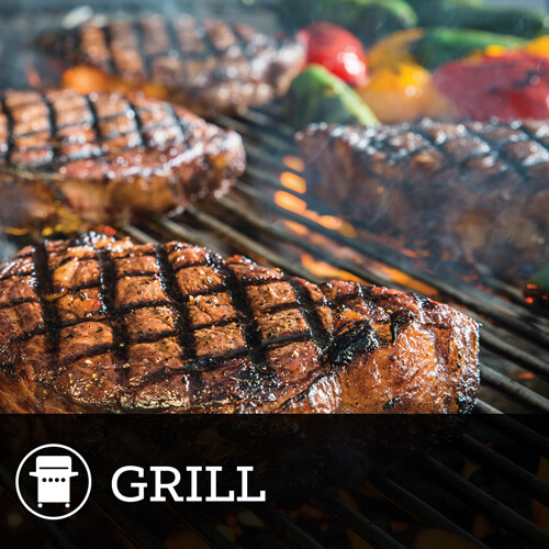 Diamond grill marked steaks cooking on grill top