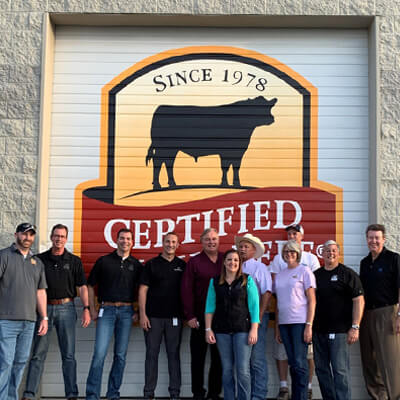 photo next to the newly painted Certified Angus Beef ® logo on a garage door.